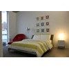 Cleveland apartment for rent - A bed with a yellow and white striped comforter.