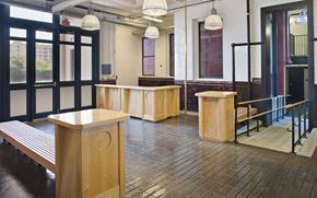 Baltimore apartment for rent - a large room with benches and desks in a building