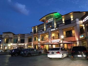 City Of Industry apartment for rent - A white car is parked in front of a building with a green light on.