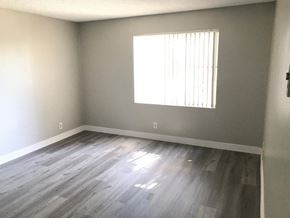 San Pedro apartment for rent - an empty room with wooden floors and a window