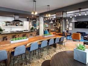Anaheim apartment for rent - A modern kitchen and dining area with a wooden table and grey chairs.