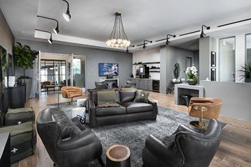 Anaheim apartment for rent - A modern living room with black leather chairs and a grey rug.