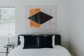 Willoughby apartment for rent - a bedroom with a bed and a painting on the wall
