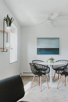 Willoughby apartment for rent - a dining room with a white table and chairs and a blue painting