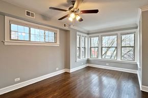 Oak Park apartment for rent - A room with a ceiling fan and a window.