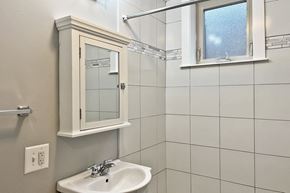 Oak Park apartment for rent - A white sink under a mirror in a bathroom.