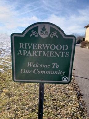 Portage apartment for rent - a sign that says riverwood apartments is welcome to our community