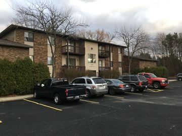 Spring Lake apartment for rent - a parking lot full of cars in front of an apartment building