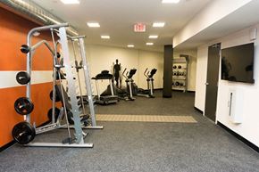 Latham apartment for rent - a gym with weights and other equipment in a room