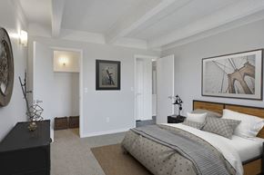 Denver apartment for rent - A bedroom with a large bed and a painting on the wall.