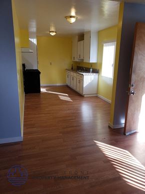Buena Park apartment for rent - A kitchen with yellow walls and wooden floors.