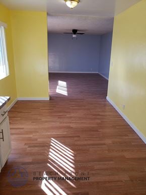 Buena Park apartment for rent - A room with wooden floors and a ceiling fan.