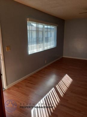 Buena Park apartment for rent - A room with wooden floors and a window letting in sunlight.