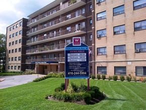 Toronto apartment for rent - a building with a street sign in front of it