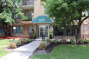 Toronto apartment for rent - an apartment building with a green awning and a tree in front