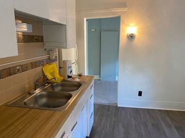Berea triplex for rent - a kitchen with a sink and a door to a hallway