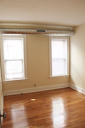Cleveland Heights apartment for rent - an empty room with a wood floor and two windows