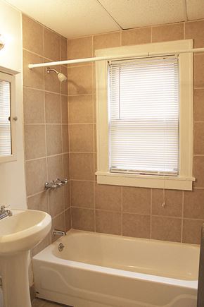 Cleveland Heights apartment for rent - a bathroom with a tub and a sink and a window
