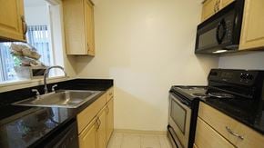 Woodmere apartment for rent - a kitchen with a sink and stove and a window