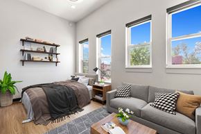 Denver apartment for rent - A bedroom with a bed, a couch, and a coffee table.