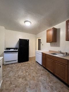 Homestead apartment for rent - a kitchen with a stove and a sink and a refrigerator