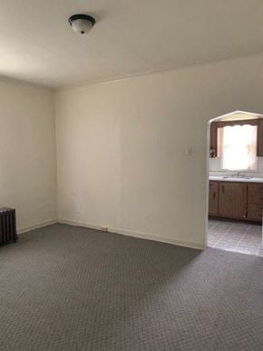 Munhall house for rent - an empty living room with a sink and a window
