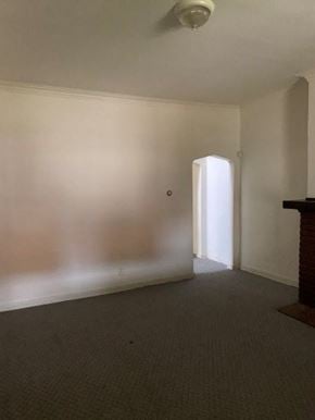Munhall house for rent - A room with a carpeted floor and a doorway leading to another room.