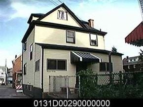 Munhall house for rent - A white house with a black roof and a black fence.