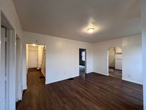 Homestead apartment for rent - A room with wooden floors and white walls.