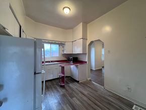 Homestead apartment for rent - A kitchen with a refrigerator, sink, and countertop.