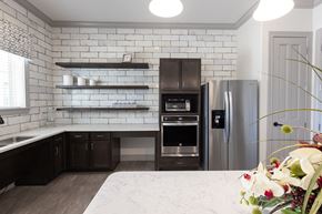 San Antonio apartment for rent - a white kitchen with black cabinets and stainless steel appliances