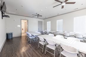 San Antonio apartment for rent - a dining room with white tables and chairs and a ceiling fan
