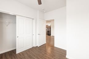 San Antonio apartment for rent - a bedroom with white walls and wood floors and a closet