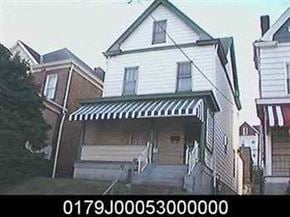 Munhall house for rent - a white house with a green and white awning