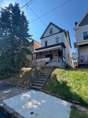 Munhall house for rent - a house with stairs and a sidewalk in front of it