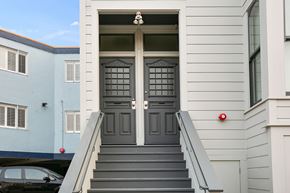 San Francisco apartment for rent - the front of a house with a black door and stairs