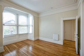 San Francisco apartment for rent - an empty living room with wood flooring and large windows
