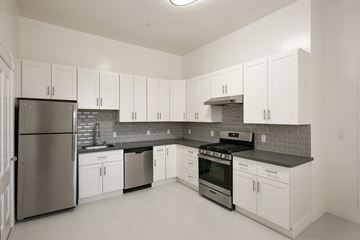 San Francisco apartment for rent - a kitchen with white cabinets and stainless steel appliances