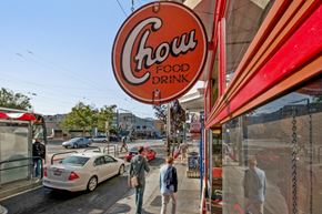 San Francisco apartment for rent - people walking on a sidewalk in front of a chow food drink sign