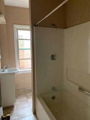 Munhall apartment for rent - a bathroom with a tub and a sink and a window