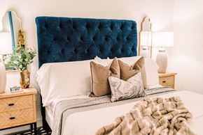 St. Louis apartment for rent - a bed with pillows and a blue tufted headboard in a bedroom