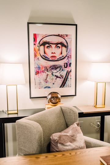 St. Louis apartment for rent - a living room with a chair and a painting on the wall