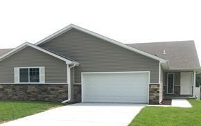 Lincoln house for rent - A house with a grey roof and a white garage door.