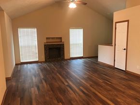 Lincoln house for rent - A room with wood flooring and a fireplace.
