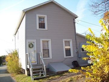 Clairton house for rent - the front of a house with a porch and stairs