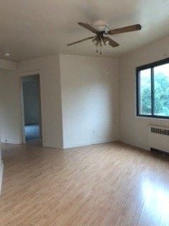 Homestead apartment for rent - an empty living room with a ceiling fan and wood floors