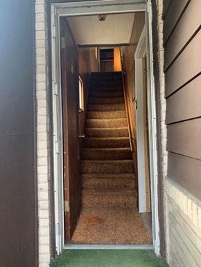 West Homestead apartment for rent - A staircase with a carpeted floor and a doorway leading to it.