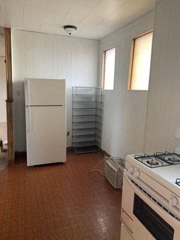 West Homestead apartment for rent - A kitchen with a white fridge, a white stove and a white oven.