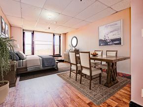 Grand Forks apartment for rent - a bedroom with a bed and a dining room table with chairs