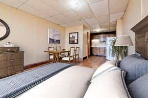Grand Forks apartment for rent - a bedroom with a bed and a living room with a kitchen